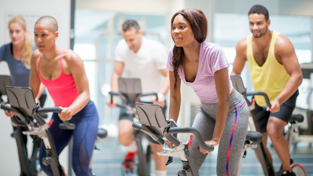 a group of people on exercise bikes